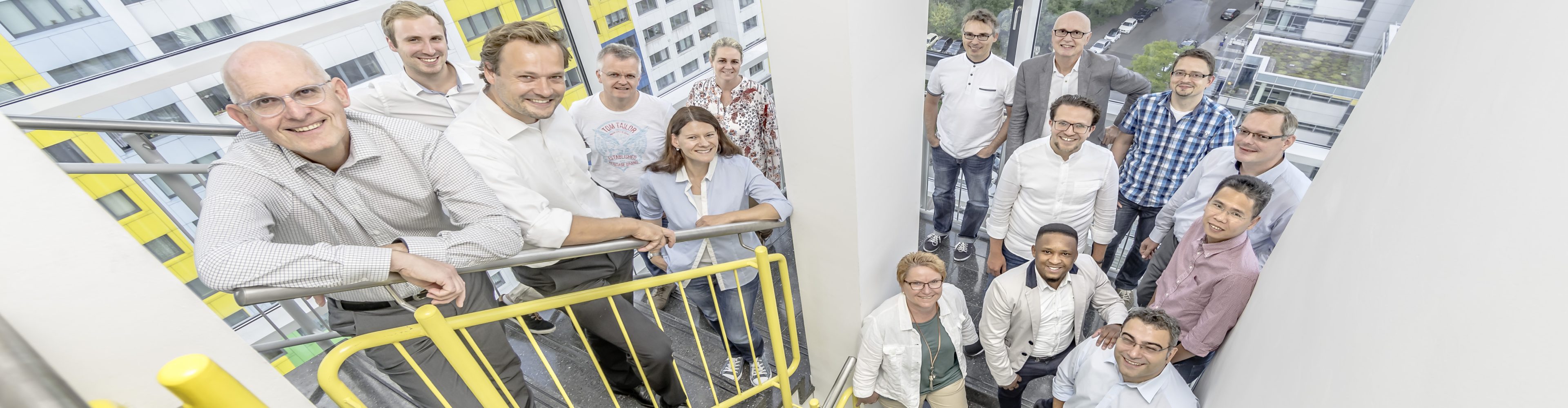A photo of GEFEG employees 2019 in a stairwell