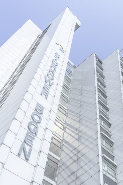 A view of a high-rise building with a vertically attached inscription 